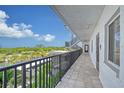 Building hallway with tiled floors and ocean views at 8911 Midnight Pass Rd # 410, Sarasota, FL 34242
