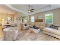 Living room with sectional sofa, large rug and adjacent dining area at 350 River Enclave Ct, Bradenton, FL 34212