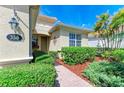 Landscaped entryway with a brick walkway leading to the front door at 350 River Enclave Ct, Bradenton, FL 34212