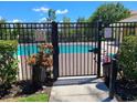 Community swimming pool area with gate and signage at 7365 Black Walnut Way, Lakewood Ranch, FL 34202