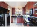 Well-equipped kitchen with dark wood cabinets at 4570 Pinebrook Cir # 603, Bradenton, FL 34209