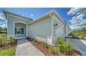 Side view of a light blue house with landscaping at 14705 Barefoot Ln, Parrish, FL 34219