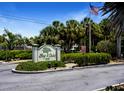 Bay Club community entrance sign and landscaping at 6157 Midnight Pass Rd # G11, Sarasota, FL 34242