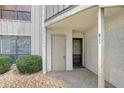 Exterior view showing condo building entrance with landscaping at 6157 Midnight Pass Rd # G11, Sarasota, FL 34242