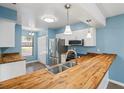 Modern kitchen with butcher block countertops and stainless steel appliances at 5412 11Th Street E Cir # 41, Bradenton, FL 34203