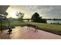 Relaxing patio overlooking a tranquil lake, perfect for enjoying sunsets at 18875 Ashcroft Cir, Port Charlotte, FL 33948