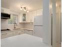 Clean white kitchen with modern appliances, bright countertop and recessed lighting at 2425 Flamingo Blvd # K28, Bradenton, FL 34207