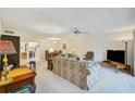 Living room with floral sofas and access to patio at 213 Rubens Dr # D, Nokomis, FL 34275
