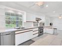 Modern kitchen with stainless steel appliances and white cabinets at 3125 Pickett St, Port Charlotte, FL 33981