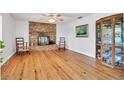 Bright living room with hardwood floors and brick fireplace at 3125 Pickett St, Port Charlotte, FL 33981