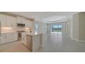 Modern kitchen with stainless steel appliances and white cabinets at 14631 Barefoot Ln, Parrish, FL 34219