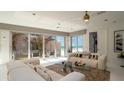 Bright living room with comfortable white sofas and sliding glass doors boasting ocean views at 107 Elm Ave, Anna Maria, FL 34216