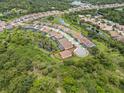 Expansive aerial view of a charming home nestled within a lush, green landscape and a vibrant neighborhood at 6600 Dovekey Dr, Sarasota, FL 34241