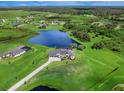 Luxury home with a lake view, expansive lot, and neighboring homes at 3582 Recurve Cir, Sarasota, FL 34240