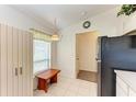 Eat-in kitchen with white cabinets, pendant lighting, and window seating near the entry at 1705 Curry Ave # 85, Nokomis, FL 34275
