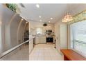 Modern kitchen with stainless steel appliances and tiled floors at 1705 Curry Ave # 85, Nokomis, FL 34275