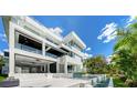 Modern luxury home with sleek architecture, an expansive balcony, and outdoor entertainment space at 1610 N Lodge Dr, Sarasota, FL 34239