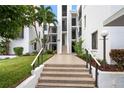 Condo building entry with stairs and landscaping at 2955 N Beach Rd # A531, Englewood, FL 34223