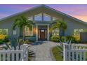 Attractive home exterior at sunset, gray brick and wood front door at 3502 Bahia Vista St, Sarasota, FL 34239