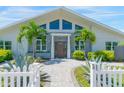 Front view of a remodeled home with gray brick and wood front door at 3502 Bahia Vista St, Sarasota, FL 34239