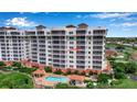 Condo building, pool, and surrounding landscape at 2825 Terra Ceia Bay Blvd # 1602, Palmetto, FL 34221
