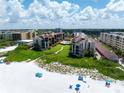 Aerial view of beachfront condos with pool and ample parking at 6480 Midnight Pass Rd # 503, Sarasota, FL 34242