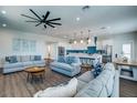 Open living space with light gray sofas, coffee tables, and hardwood floors at 2102 Avenue B, Bradenton Beach, FL 34217