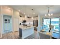 Modern kitchen with island, stainless steel appliances, and granite countertops at 2017 Lovoy Ct, North Port, FL 34288