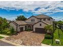 Two-story home with tile roof, two-car garage, and a basketball hoop at 6358 Rivo Lakes Blvd, Sarasota, FL 34241