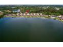 Beautiful aerial view of community homes on lake with lush green landscape and scenic views at 8930 Tuscany Isles Dr, Punta Gorda, FL 33950