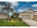 Well-maintained home featuring lush lawn, landscaping, neutral colors and two-car garage at 8930 Tuscany Isles Dr, Punta Gorda, FL 33950