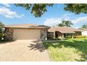 Single-story home with stone exterior and attached garage at 4607 Masefield Pl, Sarasota, FL 34241