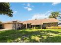 Single-story home with stone exterior and landscaped yard at 4607 Masefield Pl, Sarasota, FL 34241