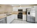 Modern kitchen featuring stainless steel appliances and white cabinetry at 3712 3Rd W Ave, Palmetto, FL 34221