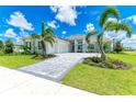 Luxury home exterior with stone accents and palm trees at 11414 Brightly Dr, Venice, FL 34293