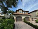 Townhouse exterior with two-car garage at 13514 Messina Loop # 102, Bradenton, FL 34211