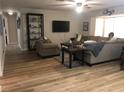 Bright living room featuring hardwood floors, comfortable seating, and built-in shelving at 222 Caddy Rd, Rotonda West, FL 33947