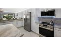 Modern kitchen with stainless steel appliances and granite countertops at 3500 El Conquistador Pkwy # 339, Bradenton, FL 34210