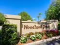 Community entrance with landscaped flower beds and signage at 4427 Longmeadow # 48, Sarasota, FL 34235