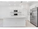 Bright kitchen with stainless steel appliances and ample countertop space at 3059 Novara Ln, Lakewood Ranch, FL 34211