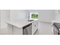 Open concept kitchen with stainless steel dishwasher and backyard access at 3059 Novara Ln, Lakewood Ranch, FL 34211