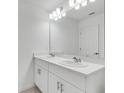 Bright bathroom featuring double vanity, quartz countertops, and contemporary fixtures, offering a clean, modern design at 3063 Novara Ln, Lakewood Ranch, FL 34211