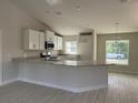 Modern kitchen featuring an island and ample counter space at 6732 Beckwith Ave, North Port, FL 34291