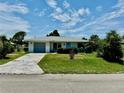 One-story house with gray garage door, and a well-maintained lawn at 3553 Syracuse St, Port Charlotte, FL 33952