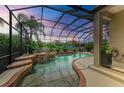 Relaxing screened pool and spa area with waterfall feature at 4713 Mainsail Dr, Bradenton, FL 34208
