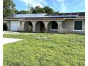 Front view of the house showcasing solar panels and landscaping at 5029 Webber St, Sarasota, FL 34232