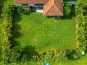 This aerial view showcases a expansive backyard framed by lush trees and manicured landscaping at 2352 Marton Oak Blvd, North Port, FL 34289