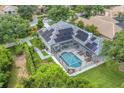 Aerial view of house with pool and solar panels at 6935 Cumberland Ter, University Park, FL 34201
