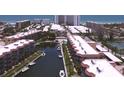 Aerial view showcasing waterfront condos with boat docks and canal access to the ocean at 1300 N Portofino Dr # 208, Sarasota, FL 34242