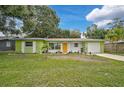 Cute ranch home features a freshly painted exterior and landscaping at 3109 Mcintosh Rd, Sarasota, FL 34232